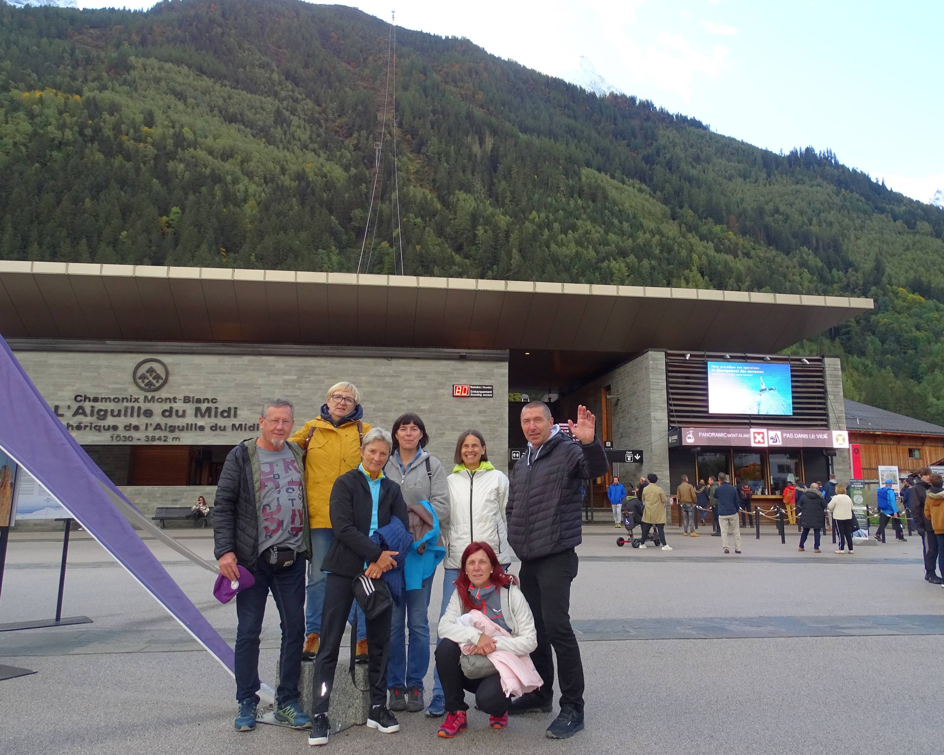 Group of people living with aphasia from Slovenia standing in front of the gondola at Chamonix, France.