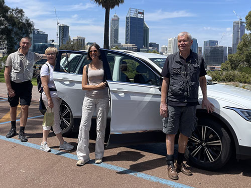 Slovenian aphasic group in Perth Australia standing in a view of the city Perth.